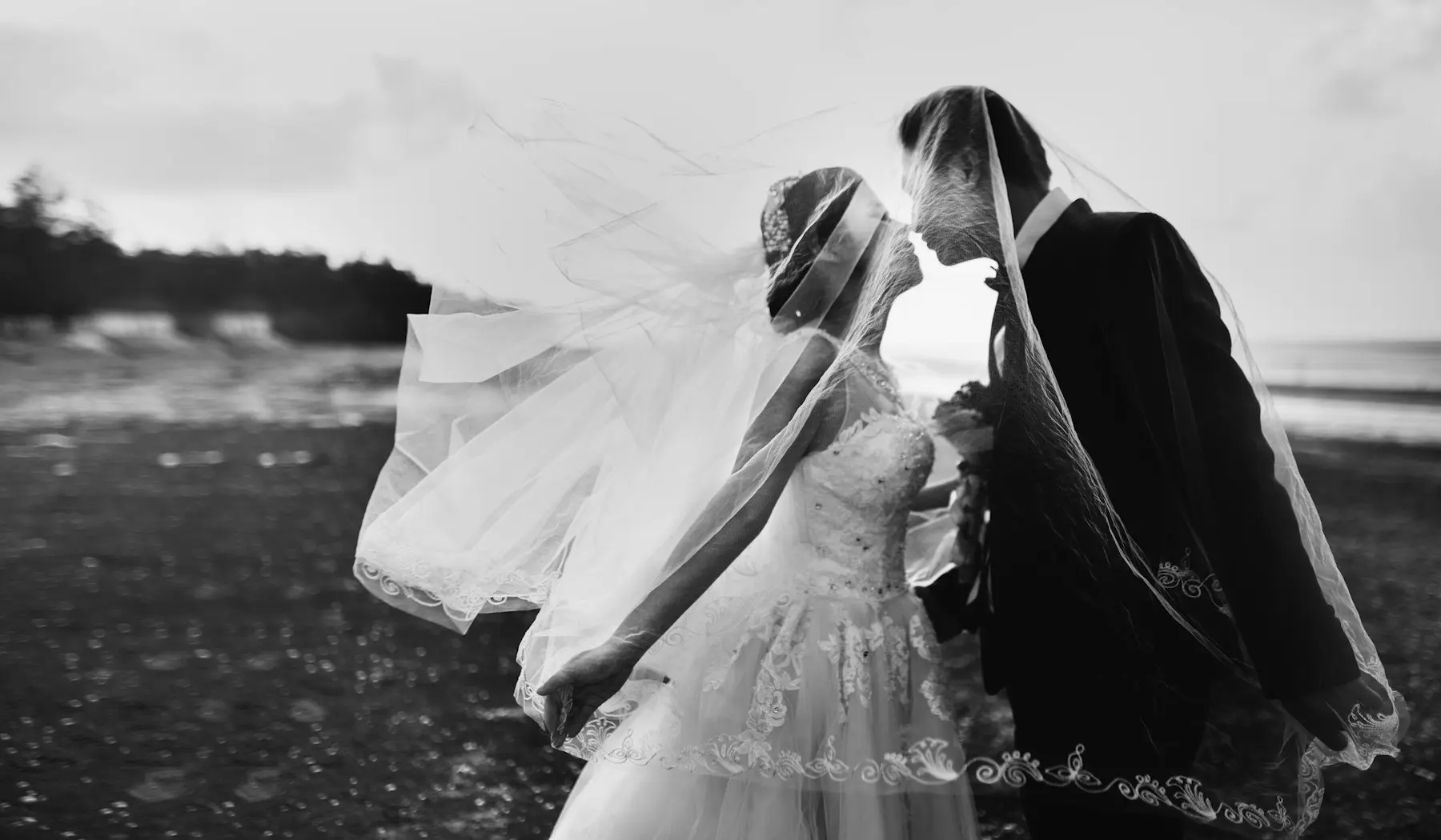 Black and white photo of a wedding kiss