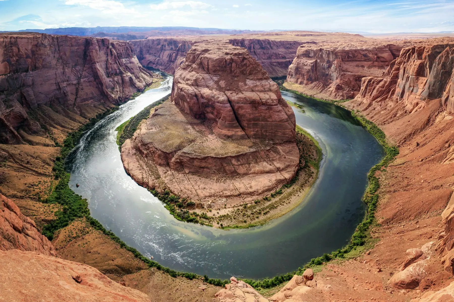 River curving through a deep red sandstone canyon