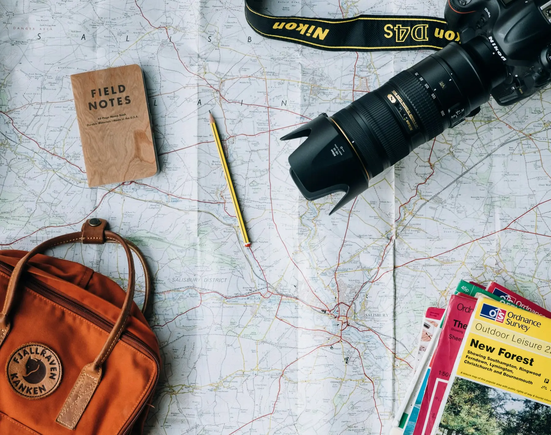 Travel planning flat lay with a camera and backpack